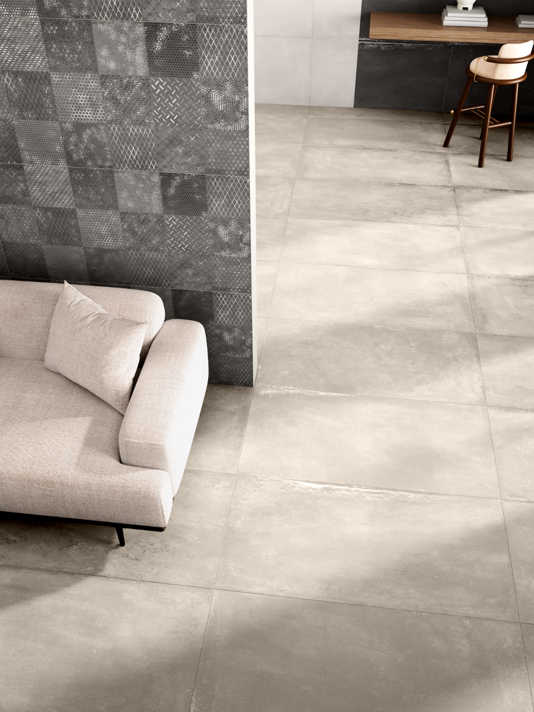 CarvoTech Gris decor meeting a warm large-format floor, seen from above at the edge of a seating area